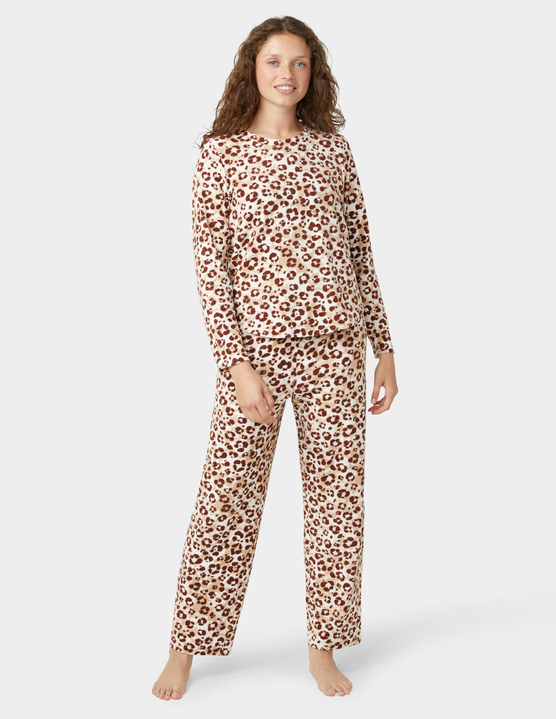 Woman wearing leopard print pajamas on a white background