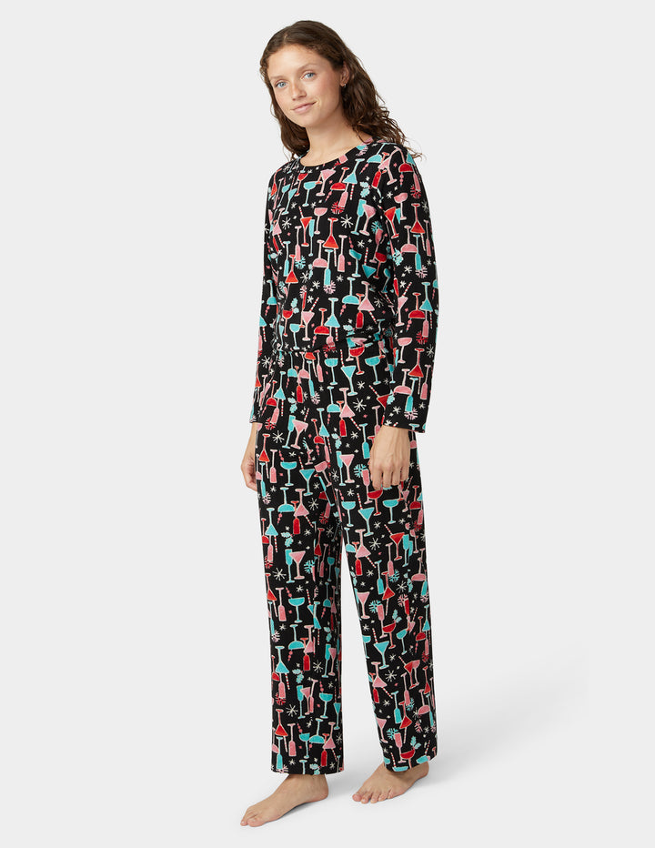 Woman wearing a patterned pajama set on a white background