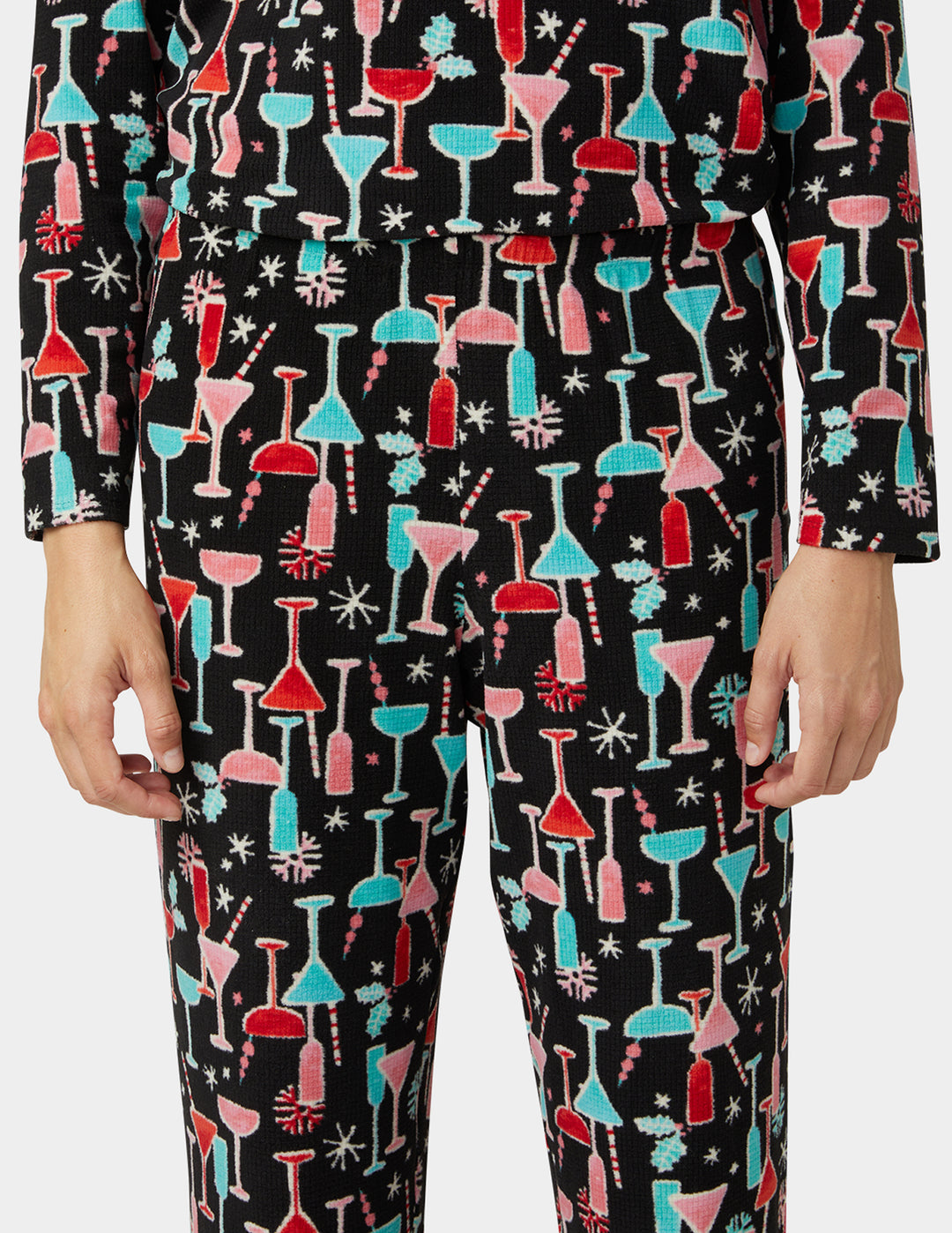 Pajama pants with colorful cocktail glass pattern on a black background