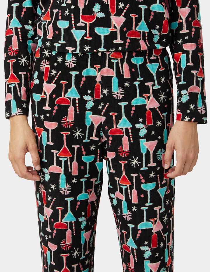 Pajama pants with colorful cocktail glass pattern on a black background