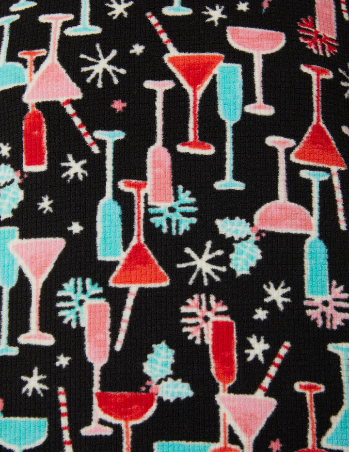 Pattern of colorful cocktail glasses and straws on a black background