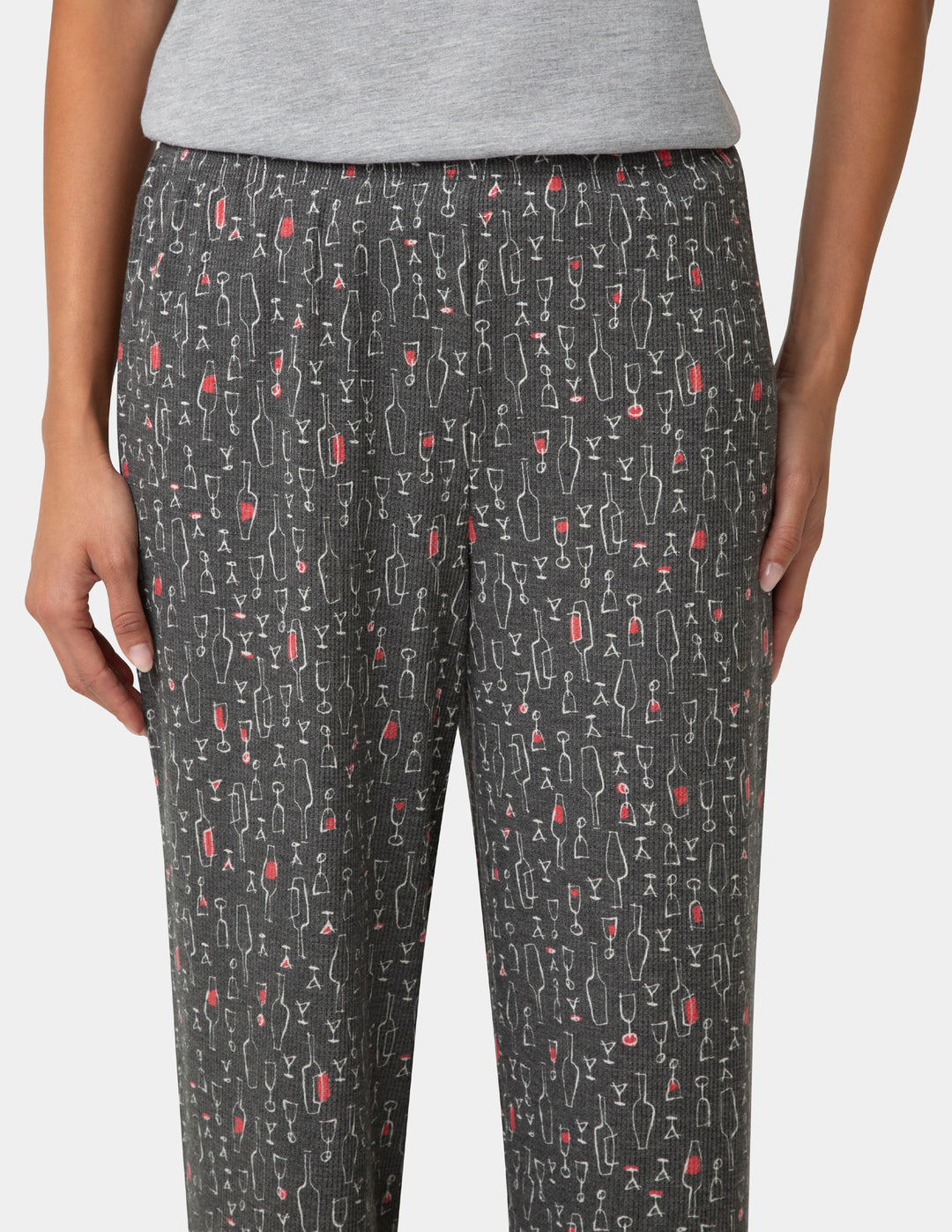 Pants with a pattern of wine glasses and bottles on a plain background