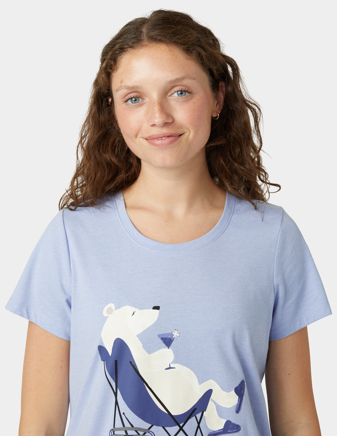 Woman wearing blue pajama t-shirt with polar bear drinking cocktail