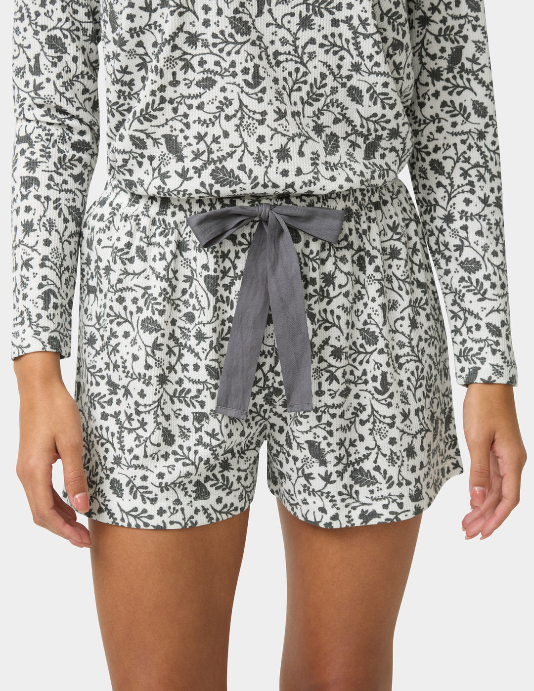 Floral patterned pajama set with gray tie on a white background