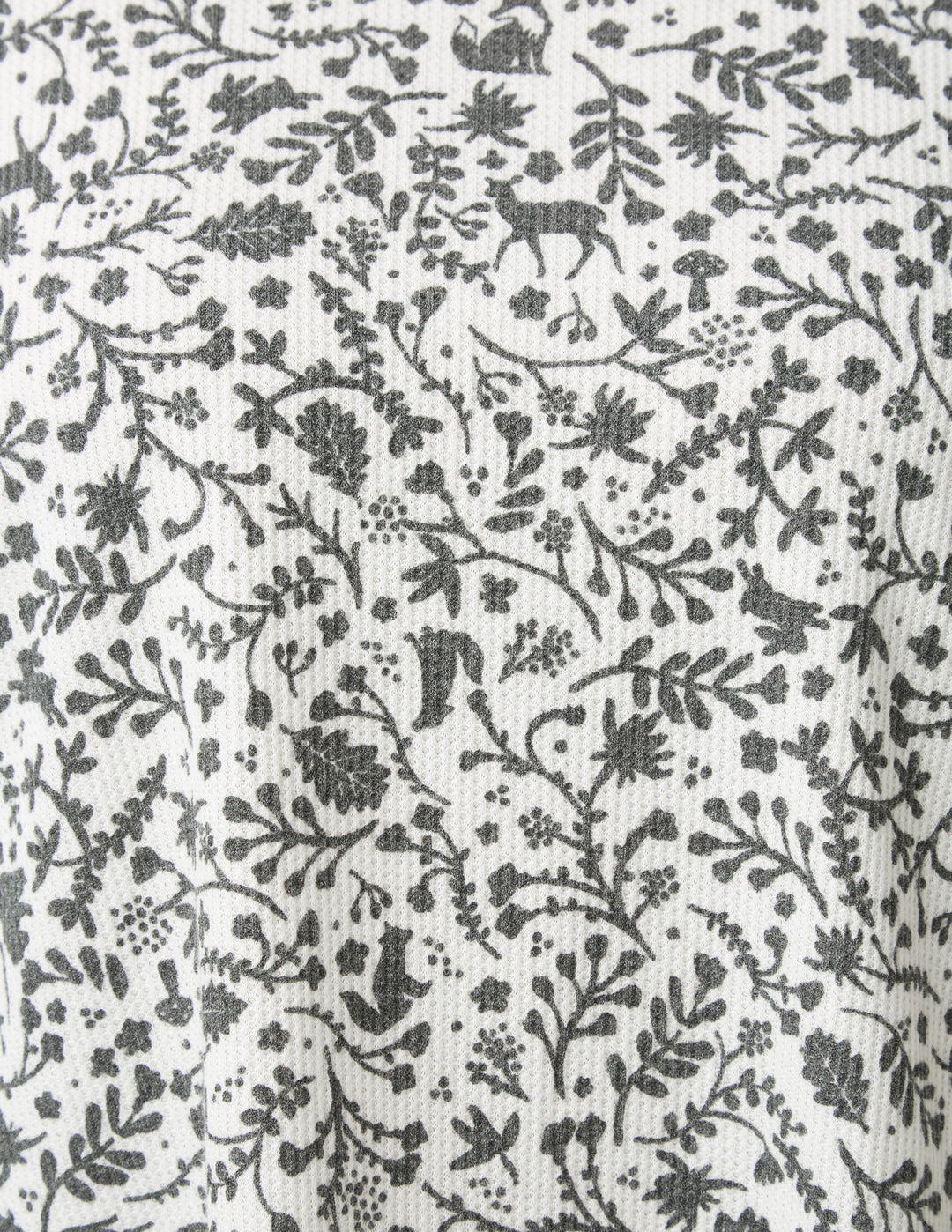 Black floral and deer pattern on a white background