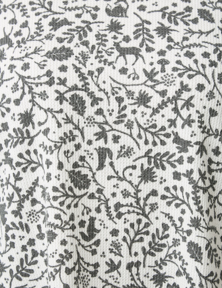 Black floral and deer pattern on a white background
