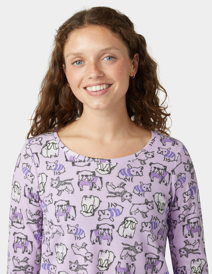 Person wearing a purple long-sleeve shirt with animal pattern on a white background