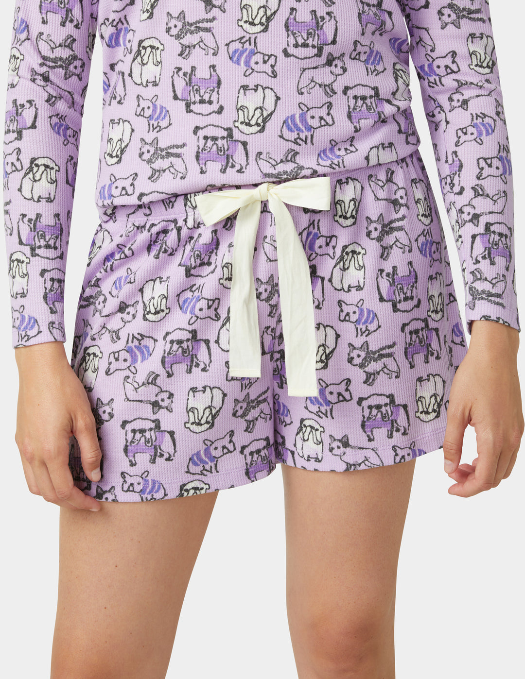 Purple pajama set with dog pattern on a white background
