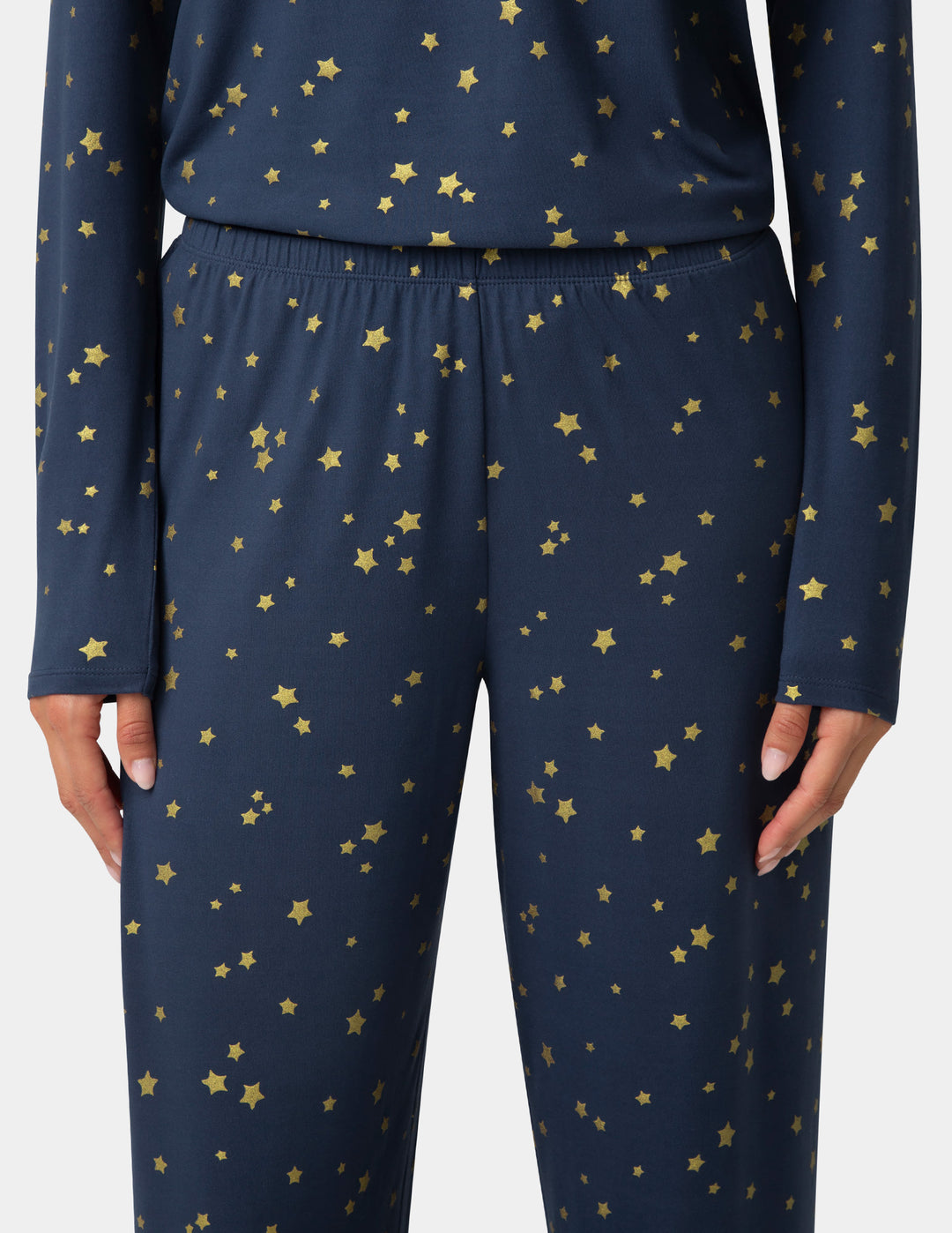 Navy pajama set with gold star patterns on a plain background