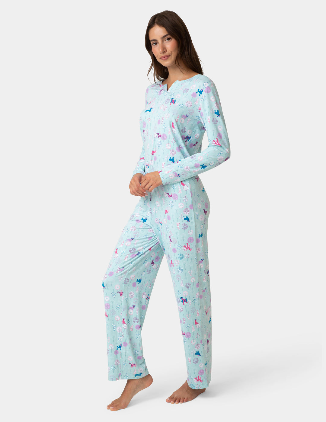 Woman wearing a light blue pajama set with colorful butterfly pattern on a white background