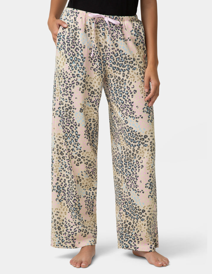 Leopard print pajama pants worn by a person on a white background