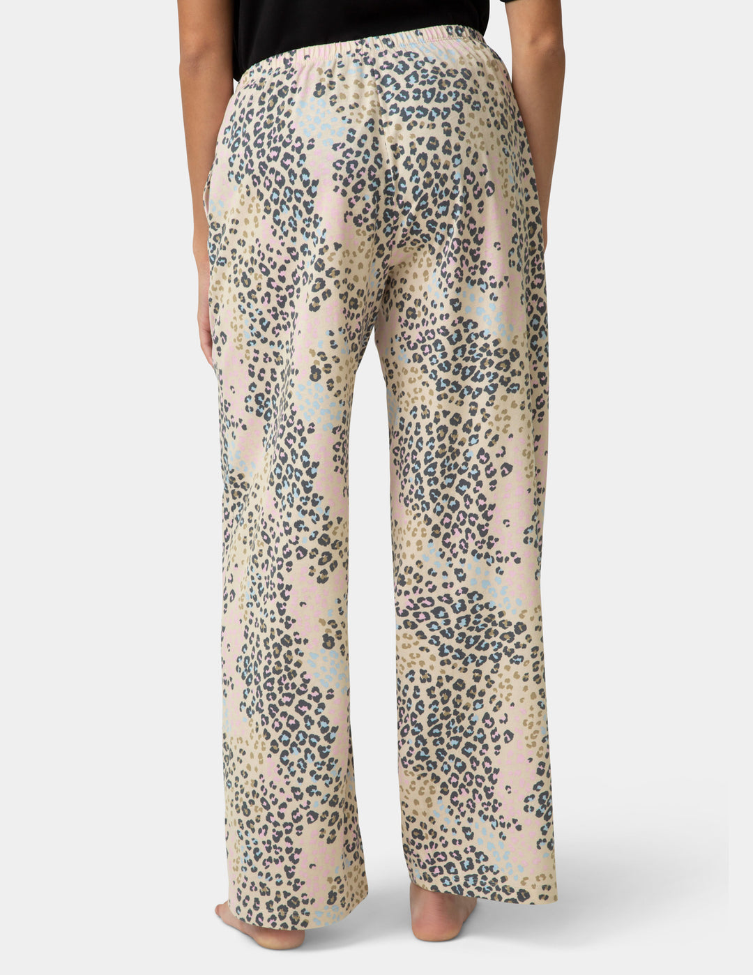 Leopard print pants worn by a person on a white background