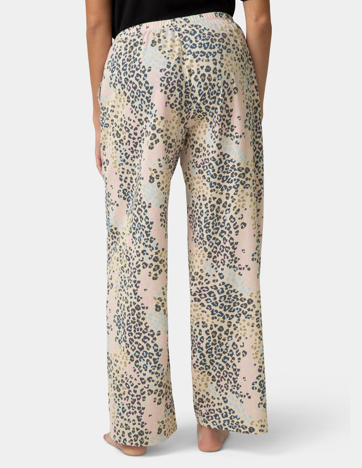 Leopard print pants worn by a person on a white background