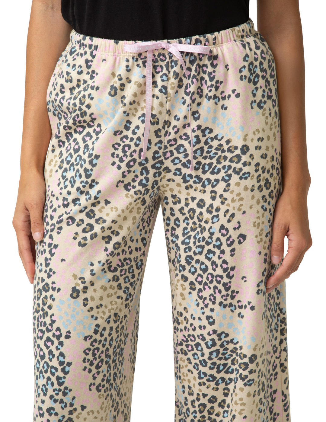 Leopard print pants worn by a person on a white background
