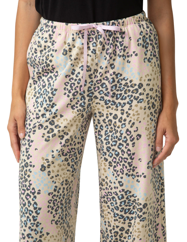 Leopard print pants worn by a person on a white background