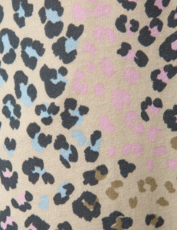 Patterned fabric with black, blue, and pink shapes on a beige background