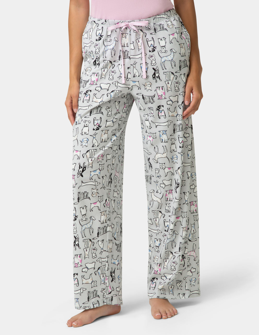 Pajama pants with cat pattern worn by a person on a white background