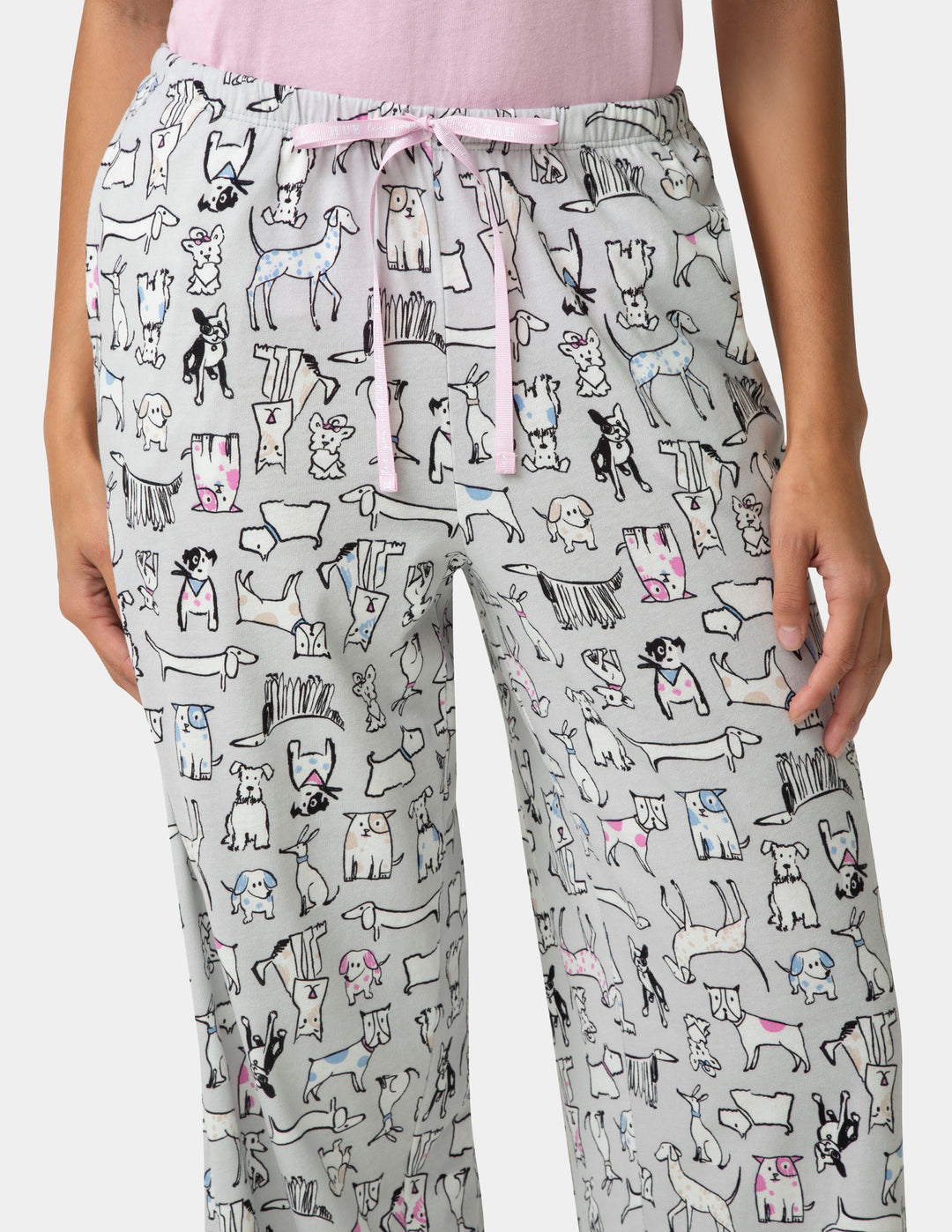 Pajama pants with dog pattern worn by a person