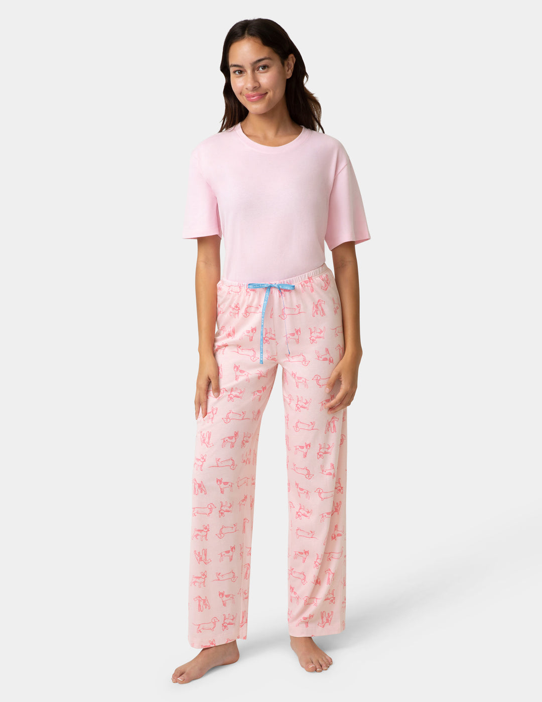 Woman wearing pink pajama set with a white background