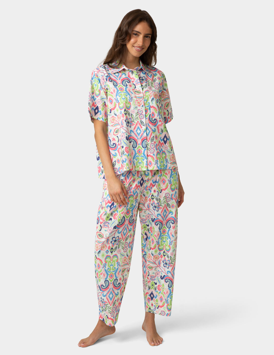 Woman wearing a colorful pajama set on a white background