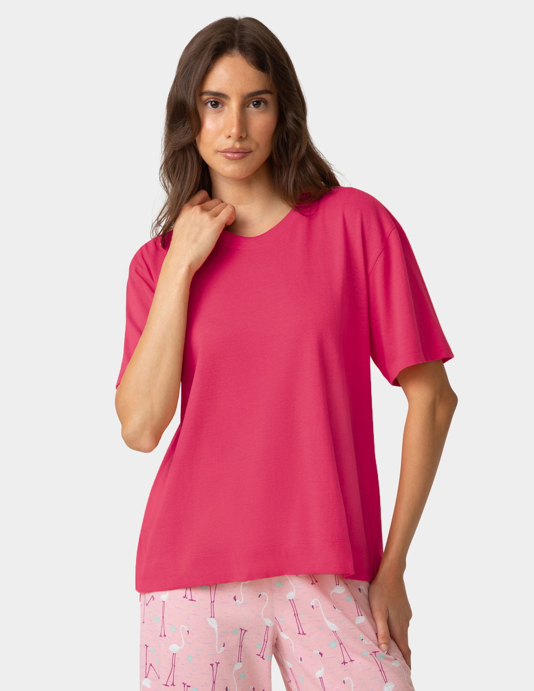 Dark pink pajama shirt worn by woman on a white background