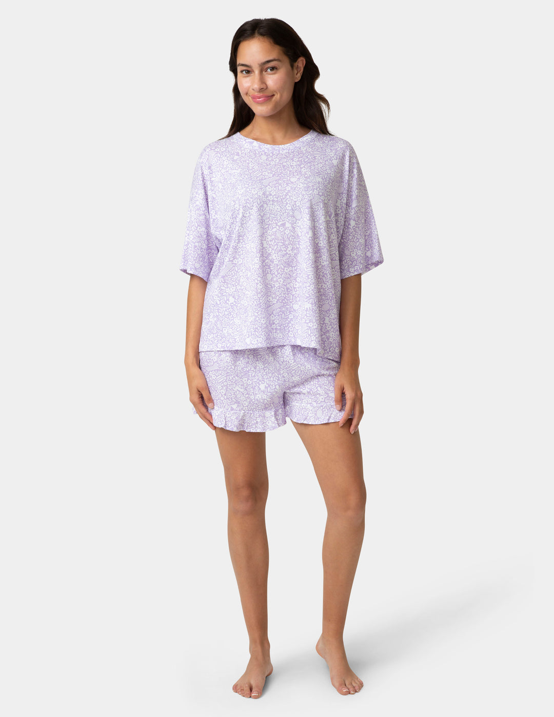 Woman wearing a light purple pajama set on a white background