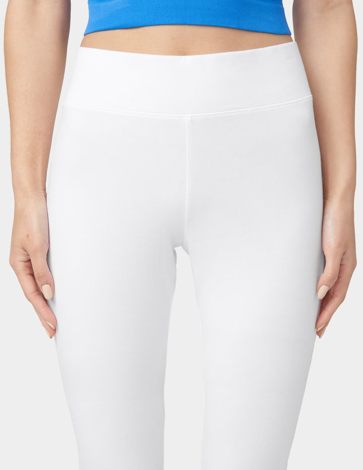 White leggings worn by a person with a blue top on a white background
