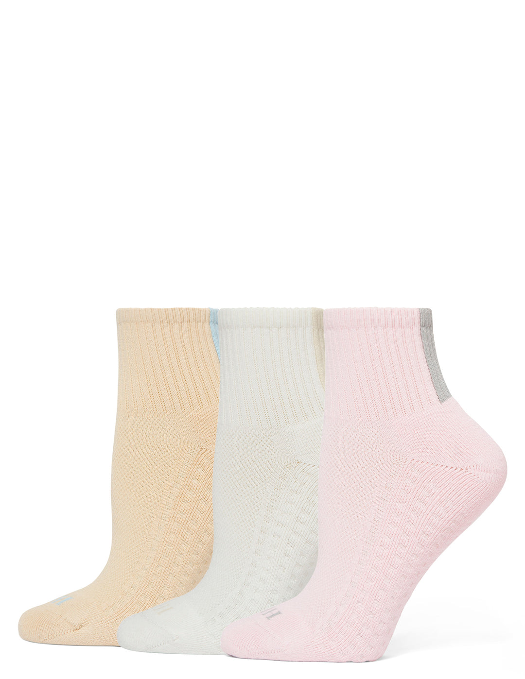 Three pairs of socks in beige, white, and pink on a white background