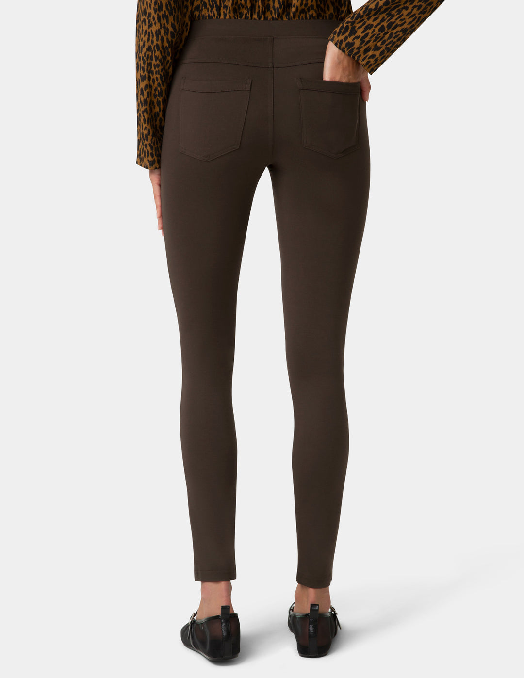 Brown pants worn by a person on a white background