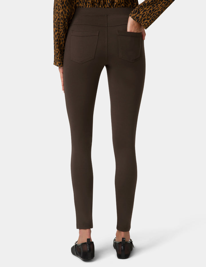 Brown pants worn by a person on a white background