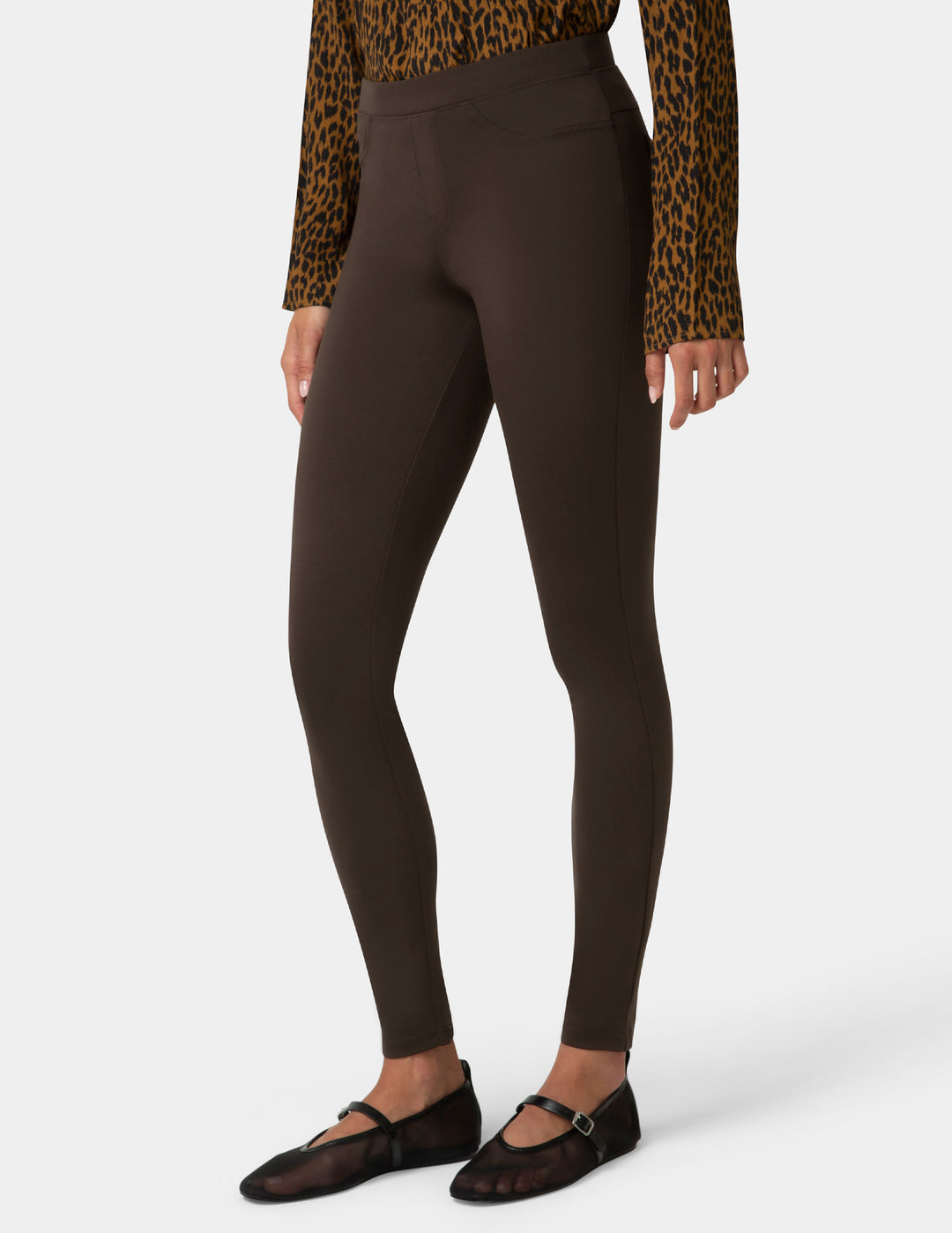 Brown leggings worn by a person on a white background