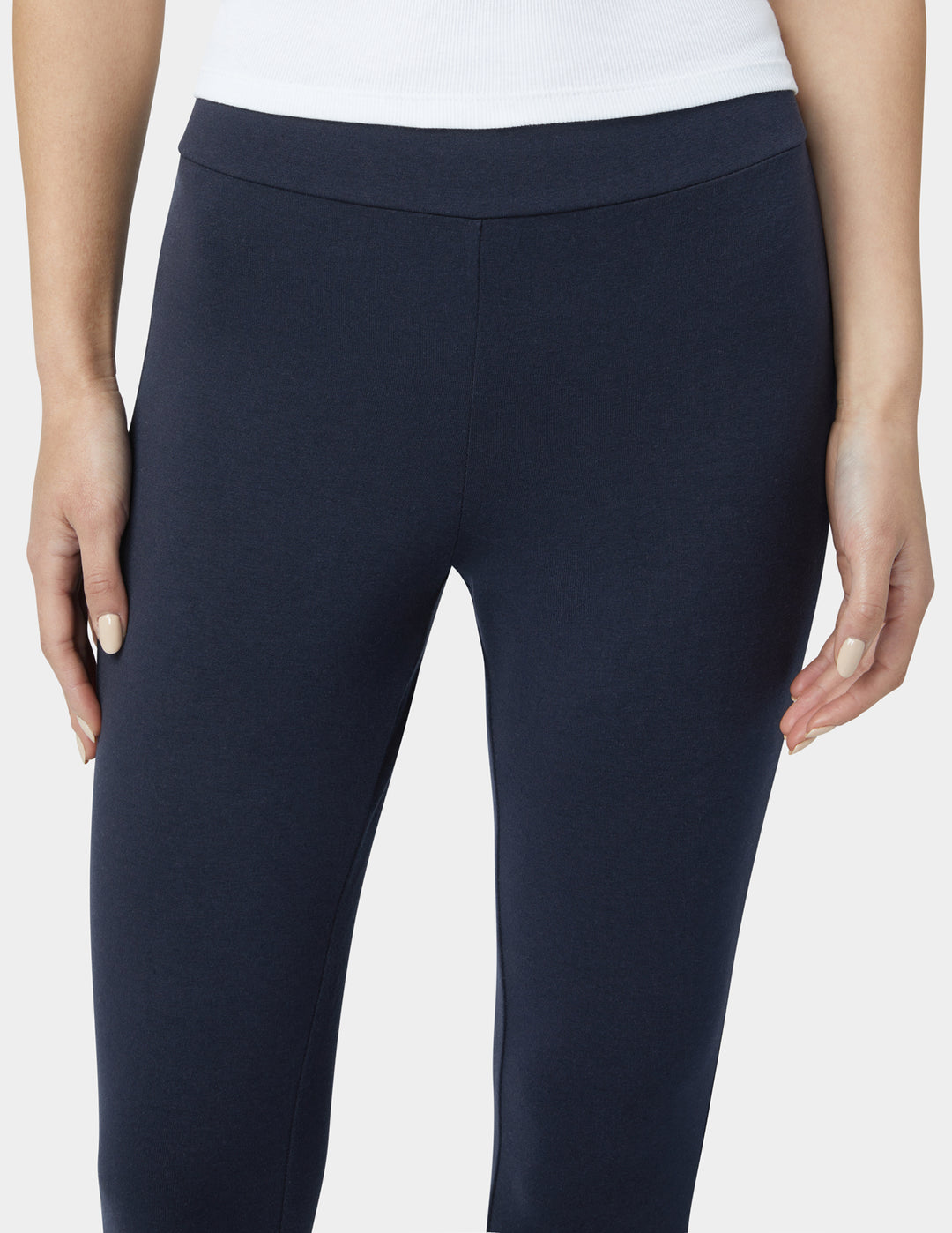 Navy blue pants worn by a person on a white background