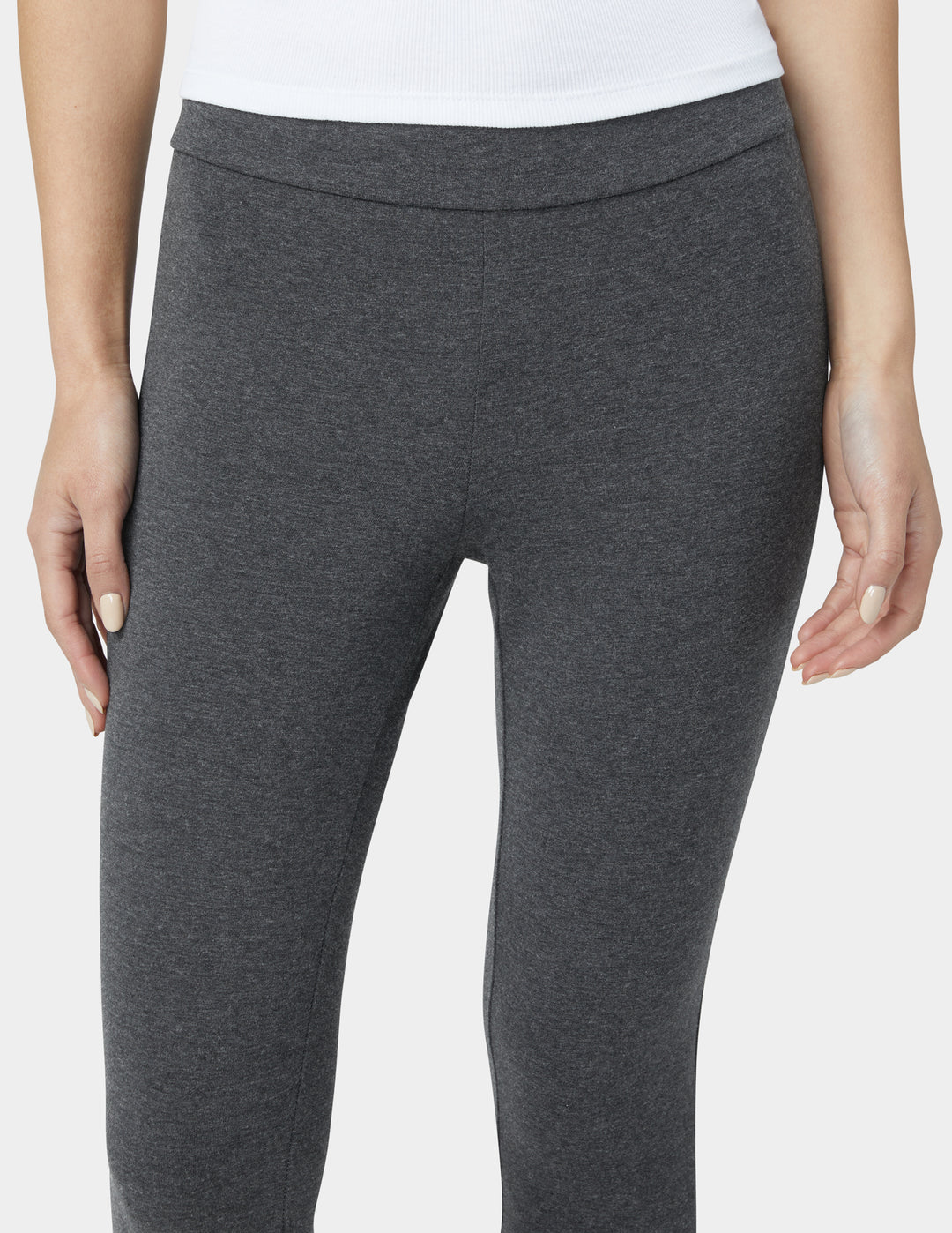 Gray leggings worn by a person on a white background