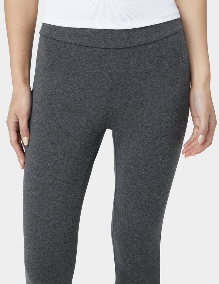 Gray leggings worn by a person on a white background