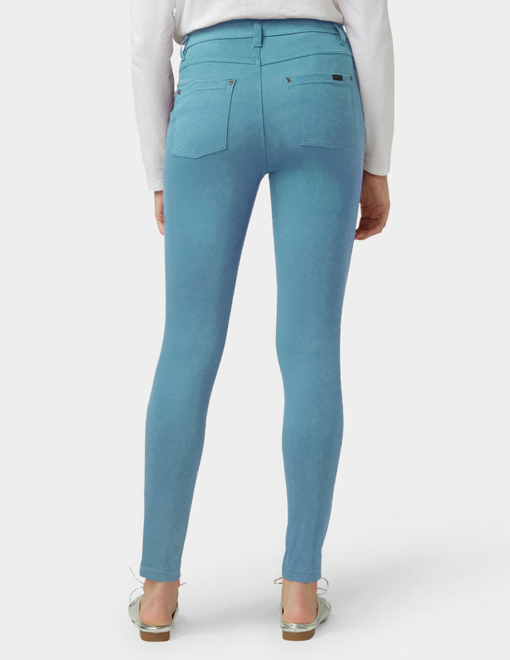 Teal pants worn by a person on a white background