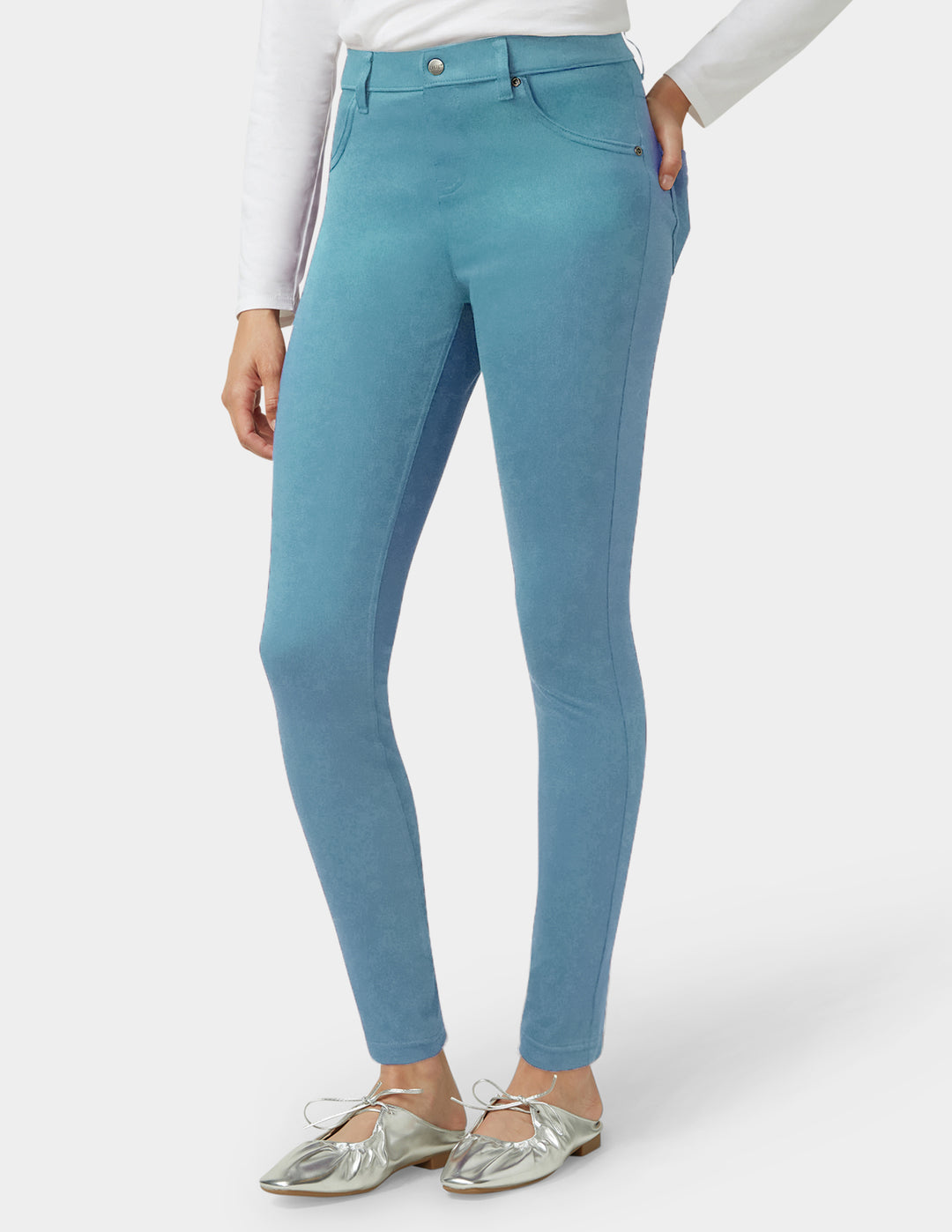 Teal pants worn by a person on a white background