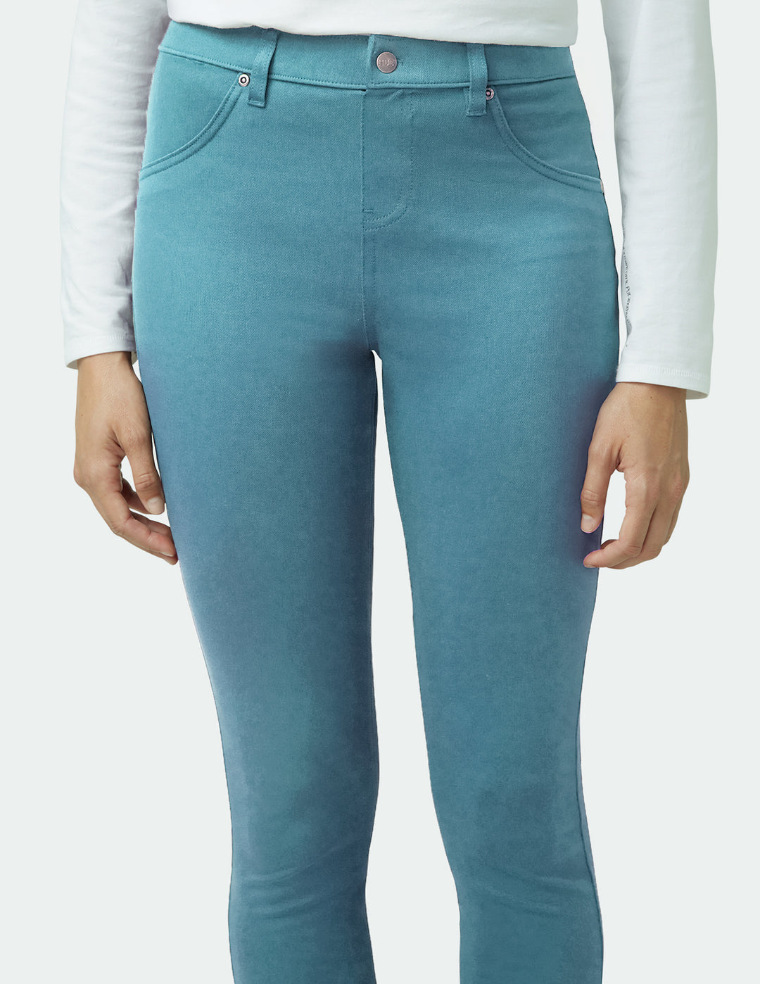 Teal pants worn by a person on a white background