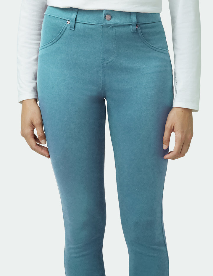 Teal pants worn by a person on a white background