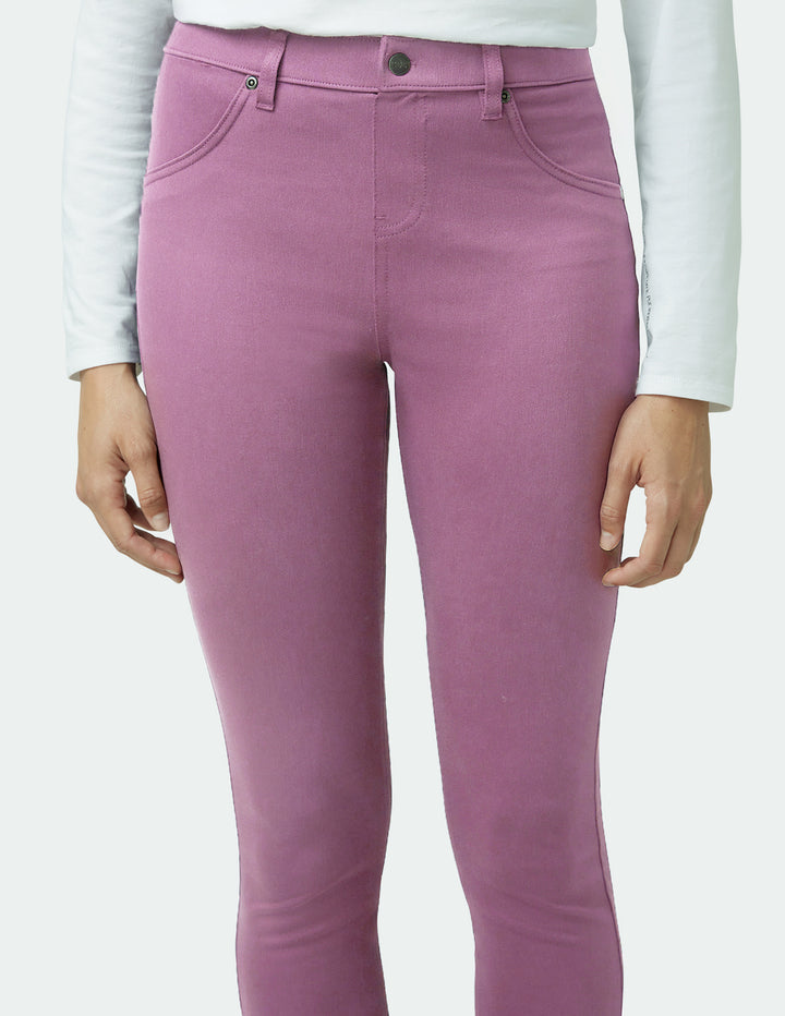 Purple pants worn by a person on a white background
