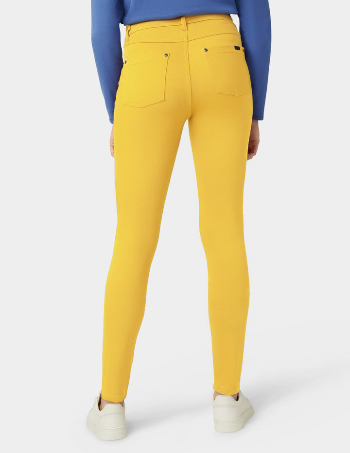 Yellow pants worn by a person on a white background