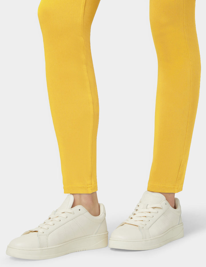 Yellow pants and white sneakers on a white background