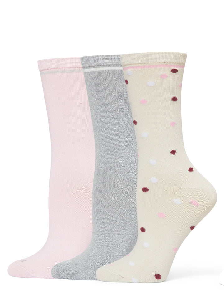 Three pairs of socks in pink, gray, and cream with polka dots on a white background