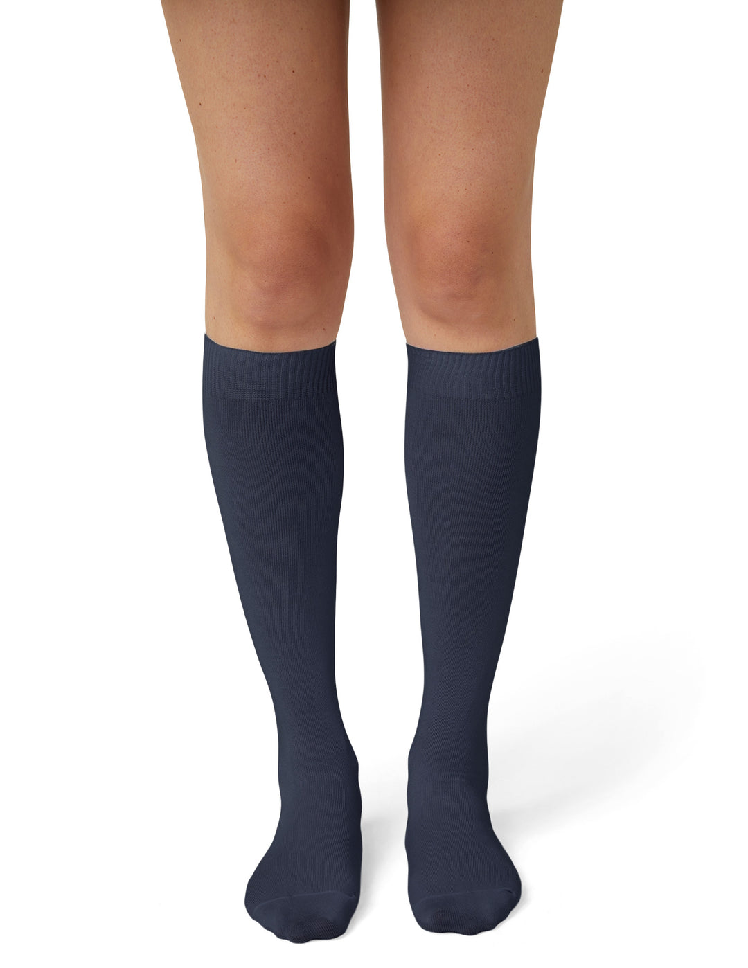 A model wearing navy knee high socks photographed against a light grey background.