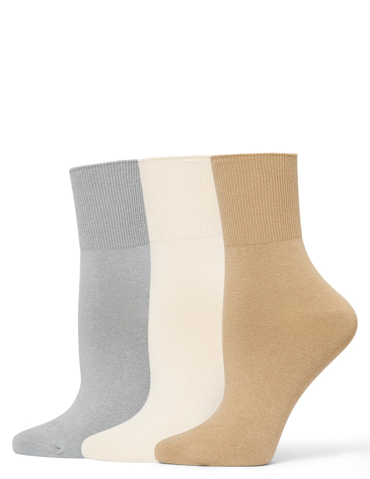 Three pairs of socks in gray, white, and beige on a white background