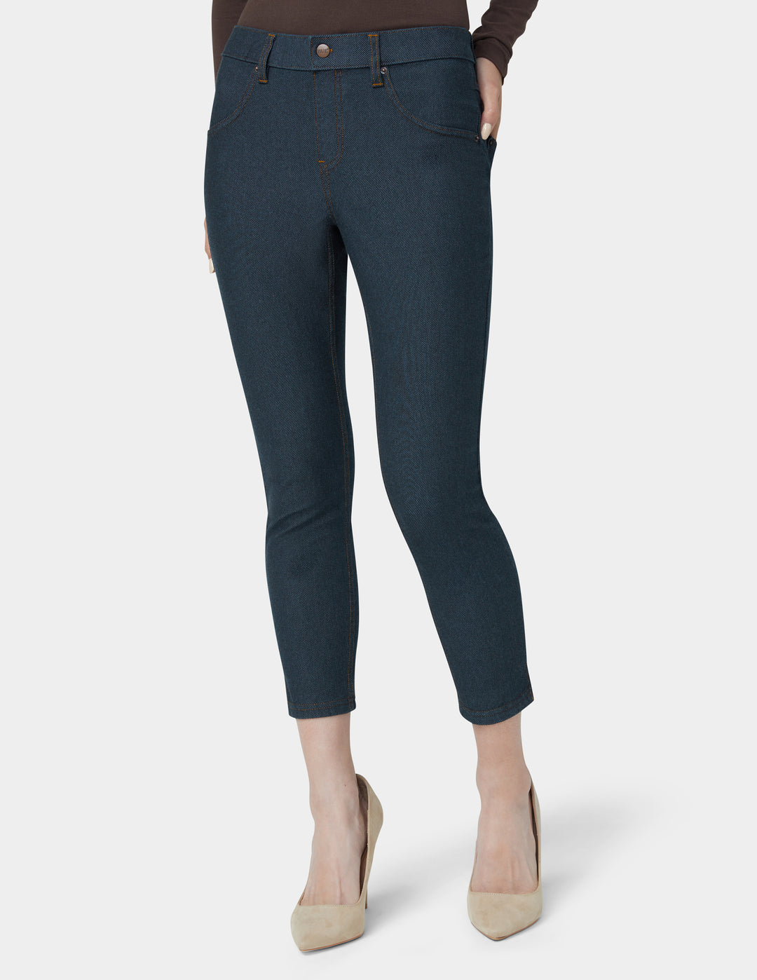 Dark blue pants worn by a person on a white background