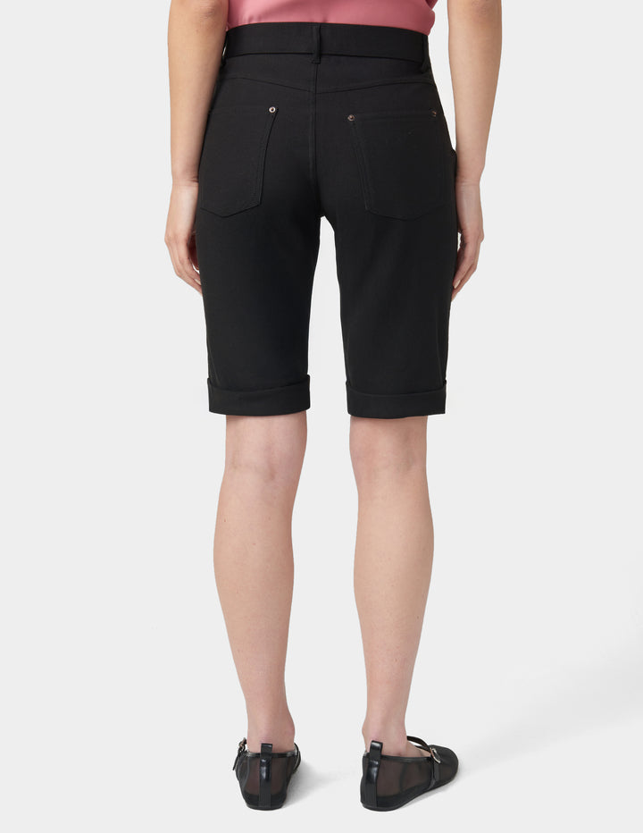 Person wearing black shorts on a white background