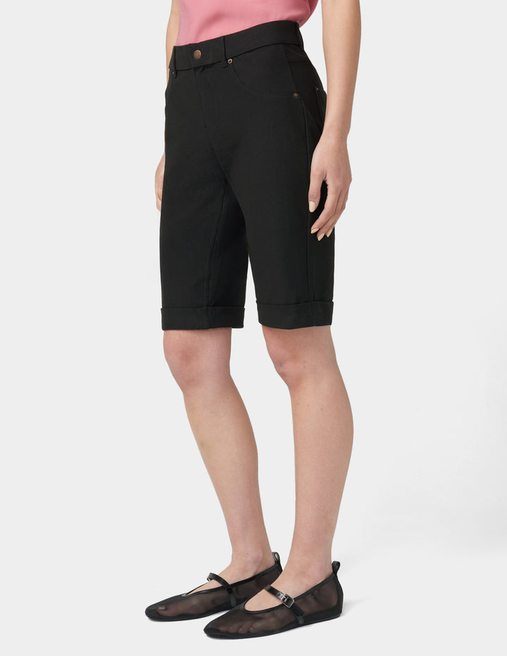 Person wearing black shorts on a white background