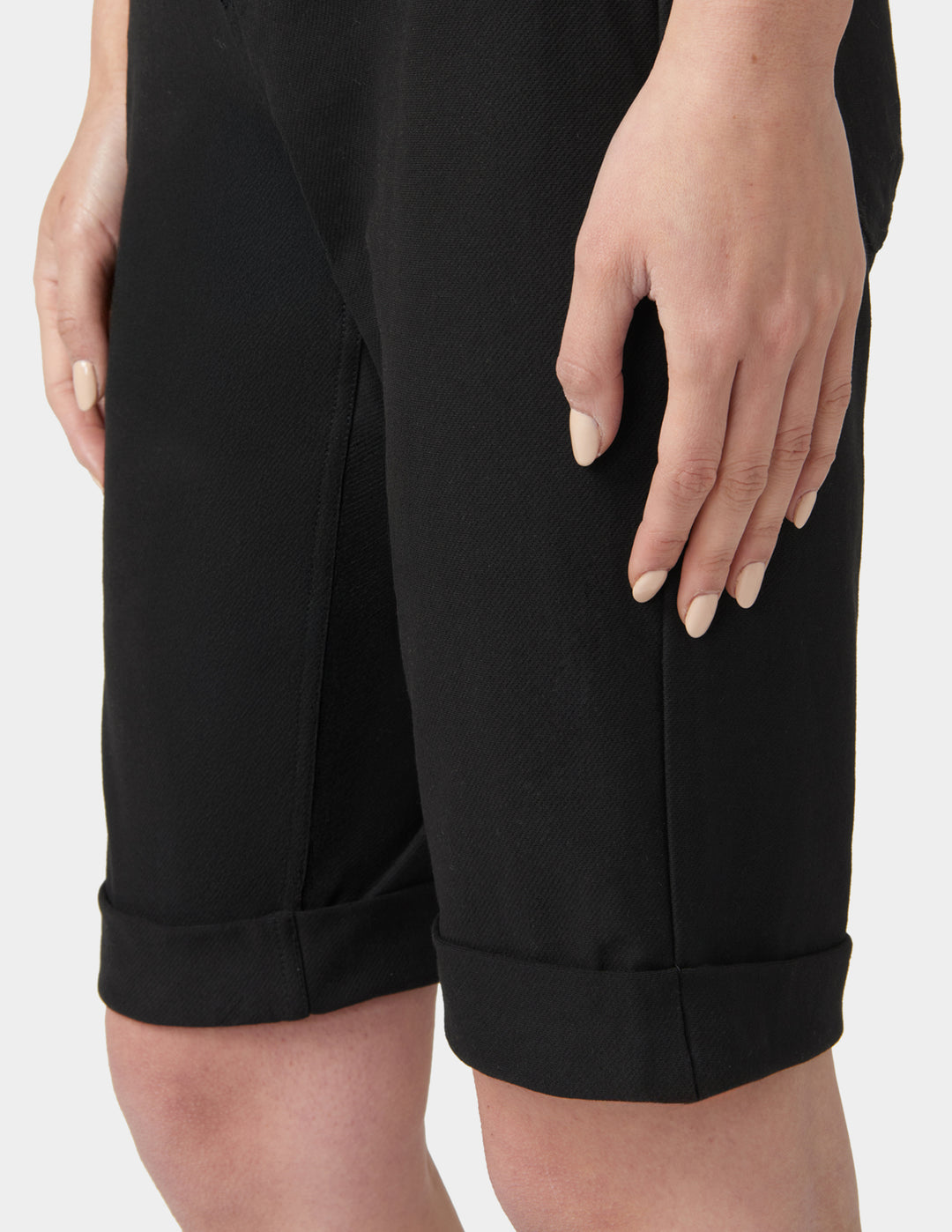 Black shorts worn by a person on a white background