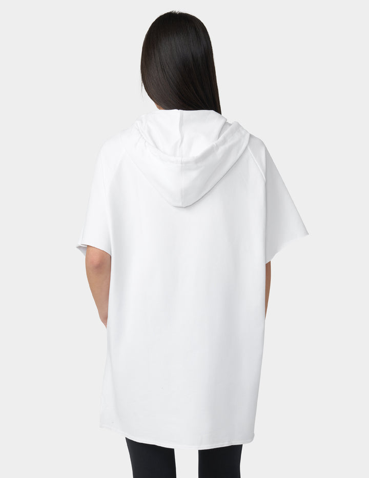 Person wearing a white hoodie from behind on a plain background