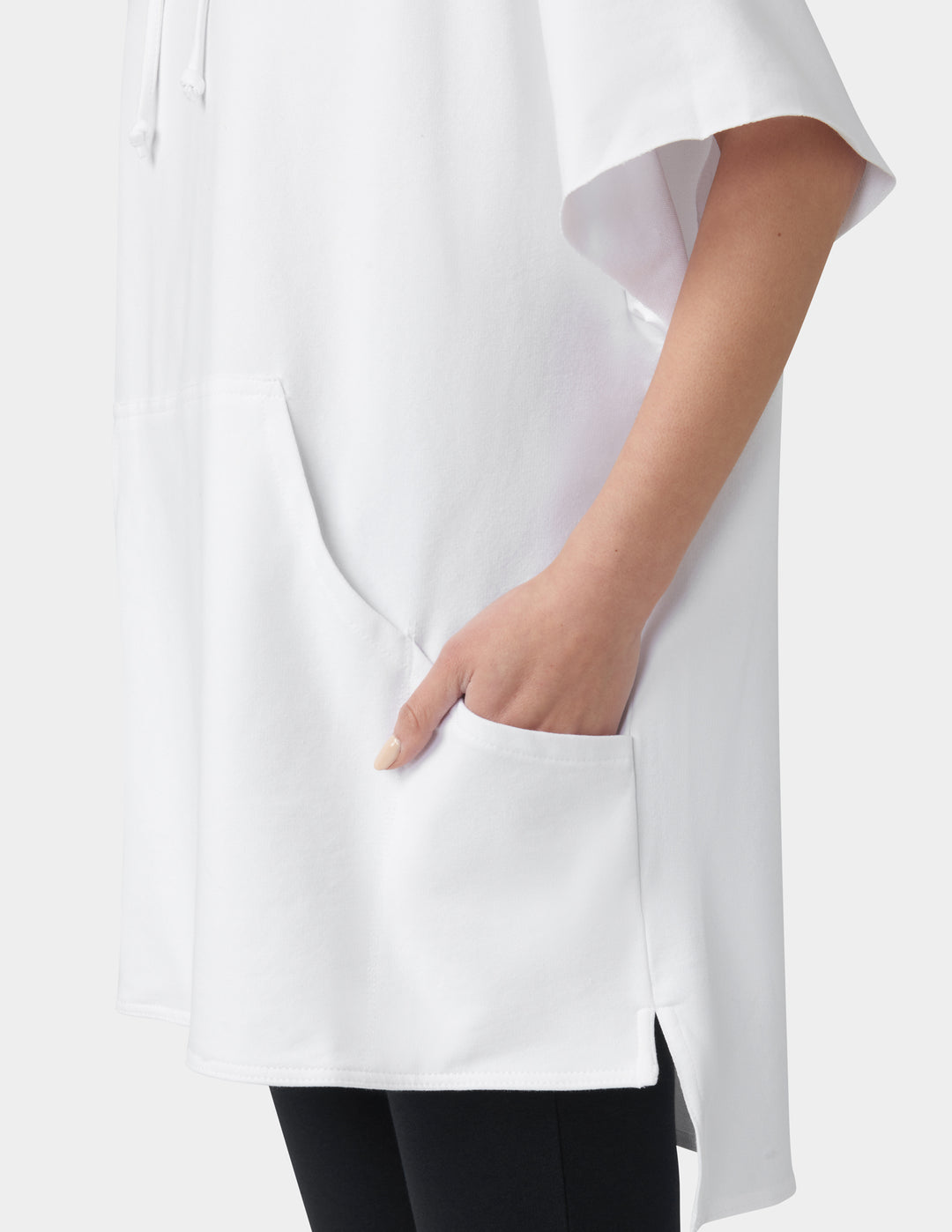 White blouse with a high-low hem and a hand in a pocket on a white background